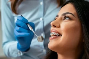 woman with braces undergoing a dental check